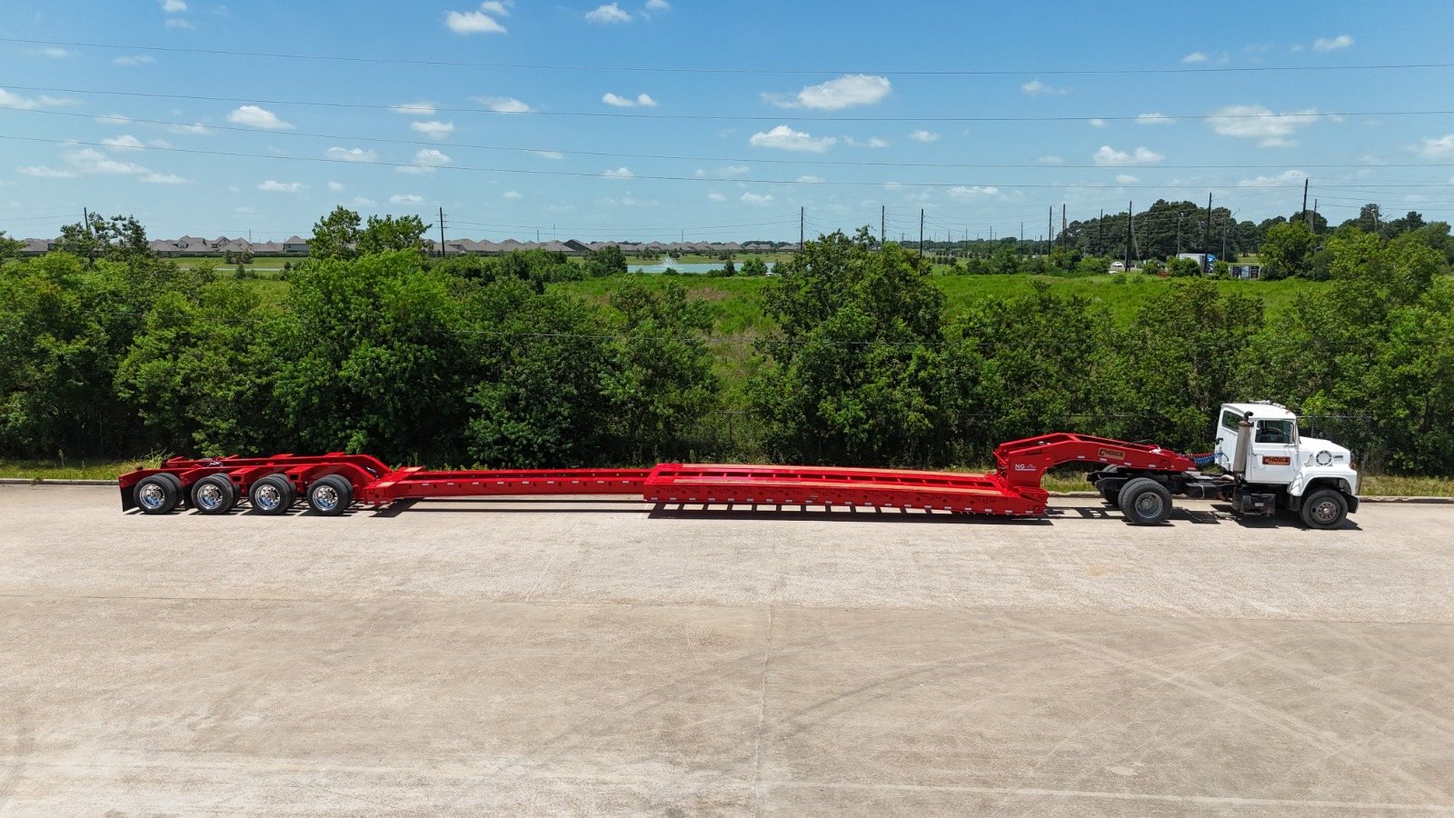 Extendable lowboy trailer hitched to a tractor with the deck extended