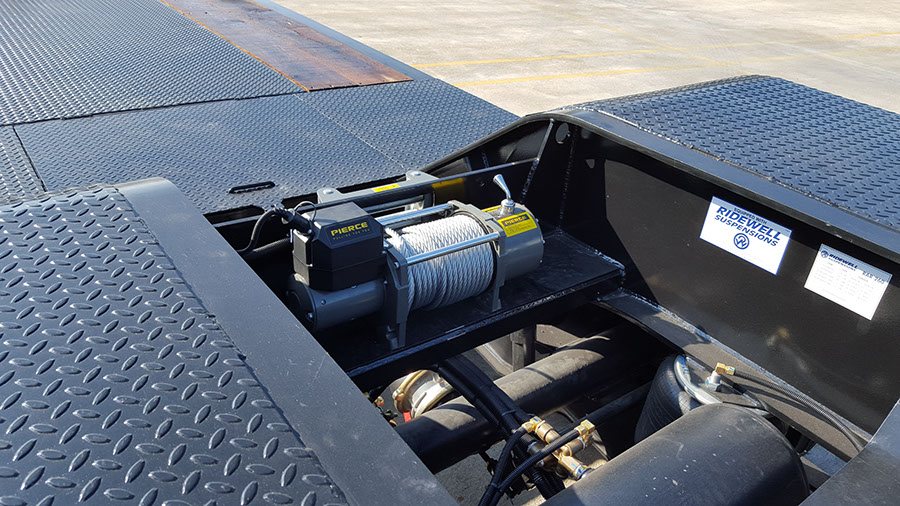 Pierce winch bay above Ridewell air-ride suspension on a lowboy trailer