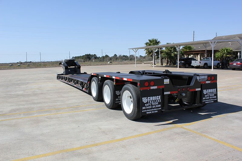 Rear three-quarter view of a black NG-Pro lowboy trailer